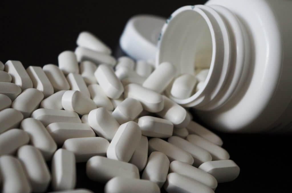 A photo of pills spilling out of a bottle