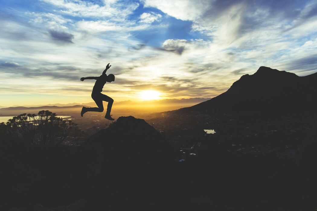 man jumping in sunset