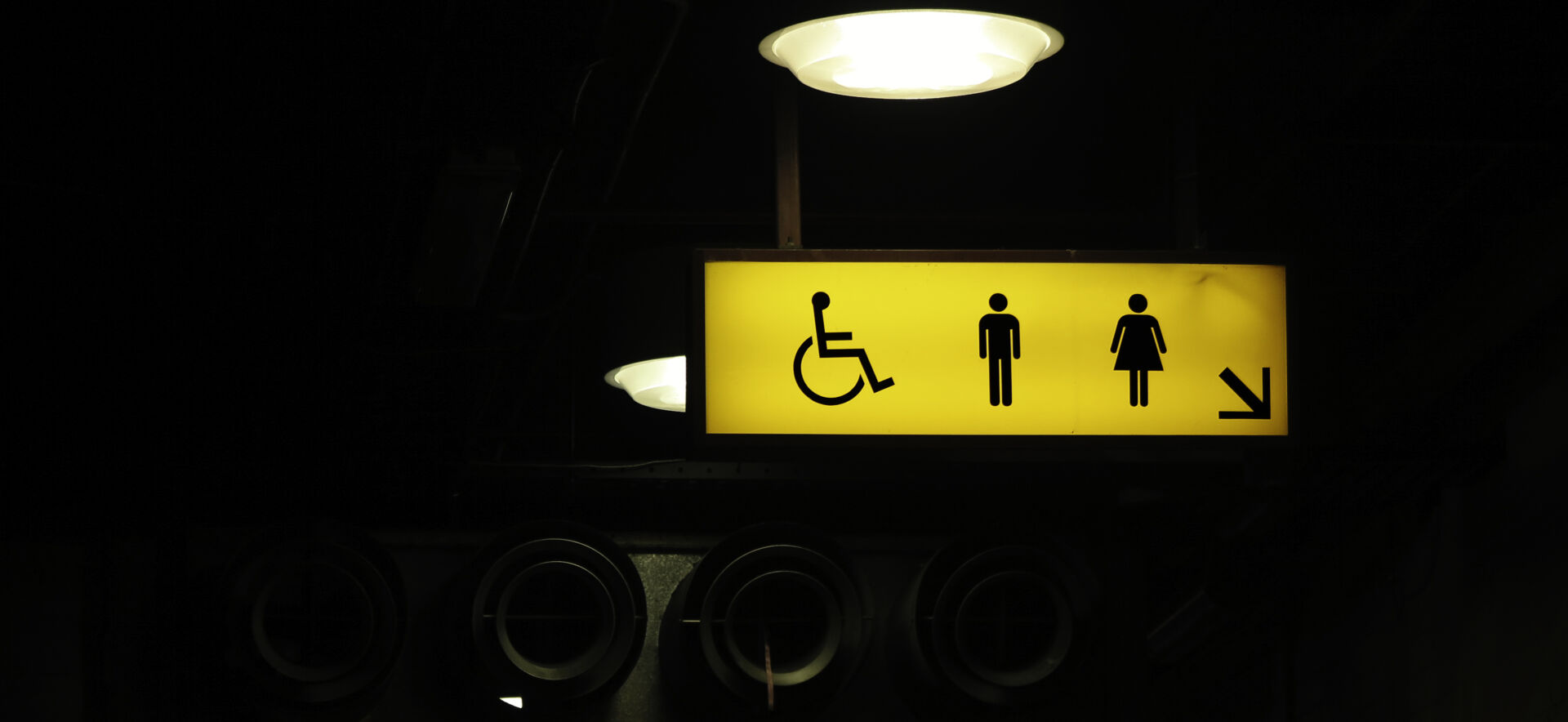 Photo of a yellow restroom sign