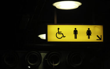 Photo of a yellow restroom sign