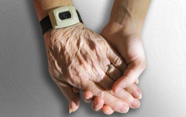 Photo of a young hand holding an aged hand