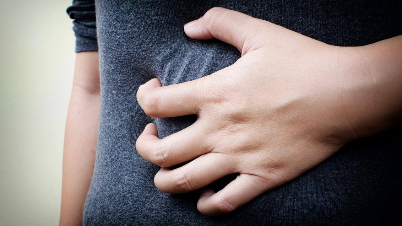 Photo of someone clenching their stomach