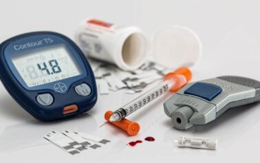 Photo of a blood sugar tester and diabetes medications