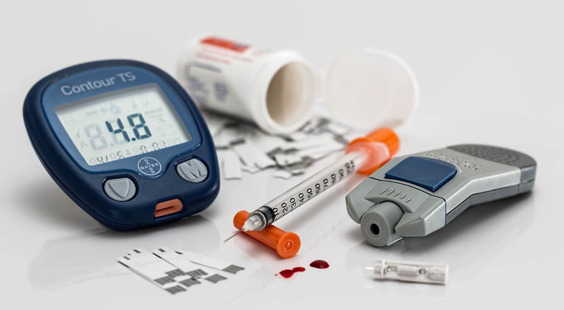 Photo of a blood sugar tester and diabetes medications